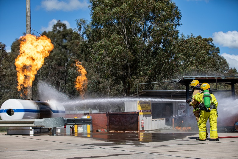 Firefighters attack a simulated service station fire